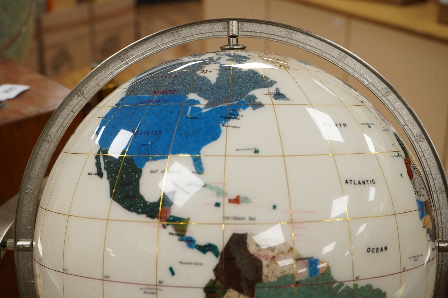 A modern globe on a chromed stand with inset minerals, 12 inch diameter globe